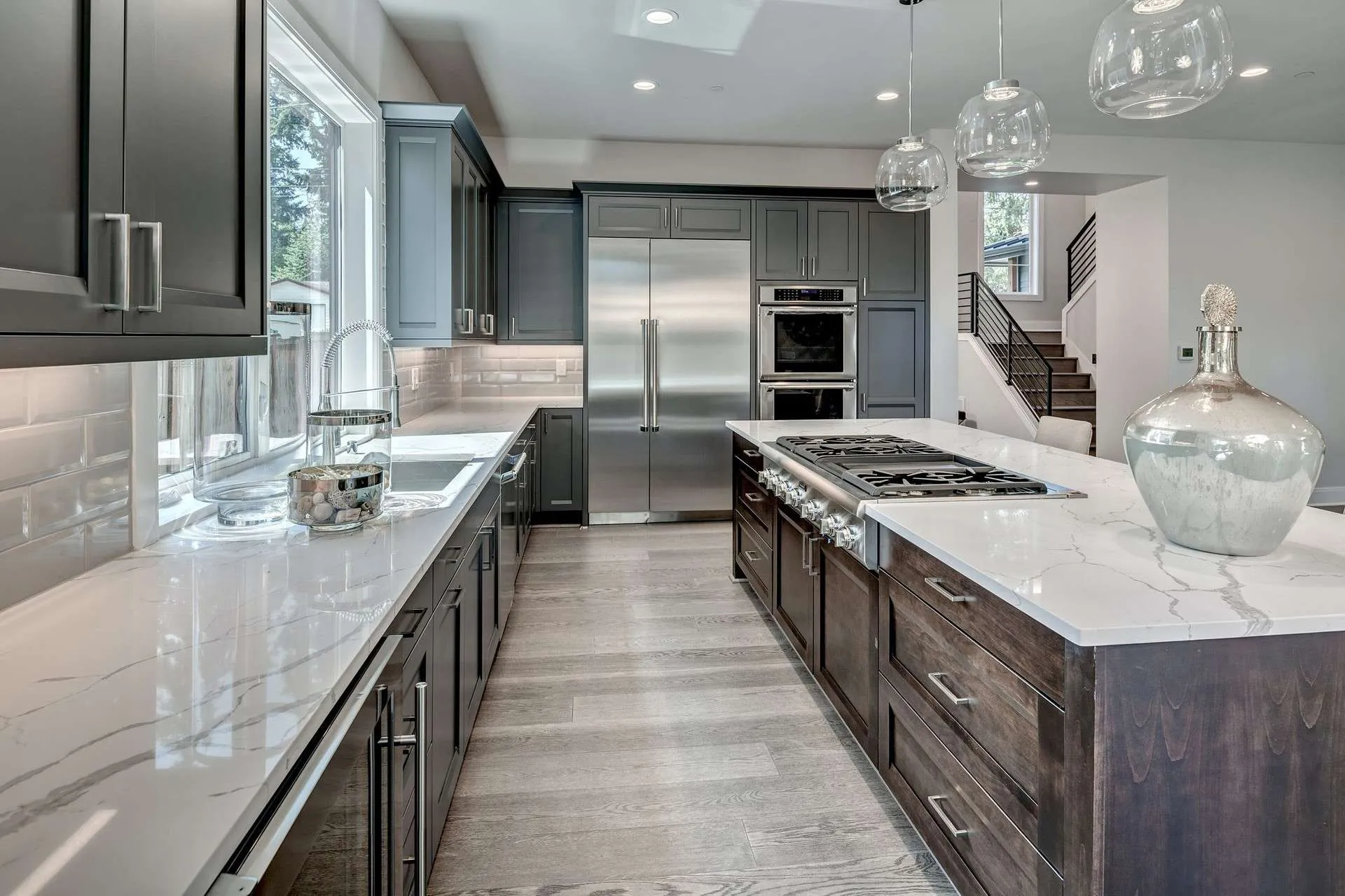 Light wood plank flooring through an open kitchen